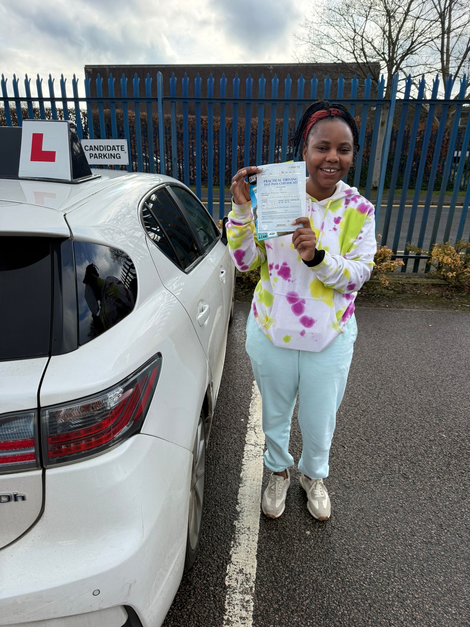 Successful Master Miles student smiling and holding driving test pass certificate and car keys